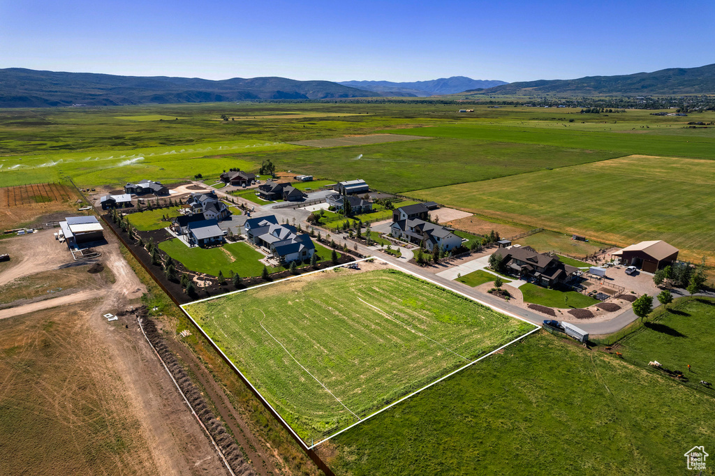 Birds eye view of property featuring a rural view, a residential view, and a mountain view