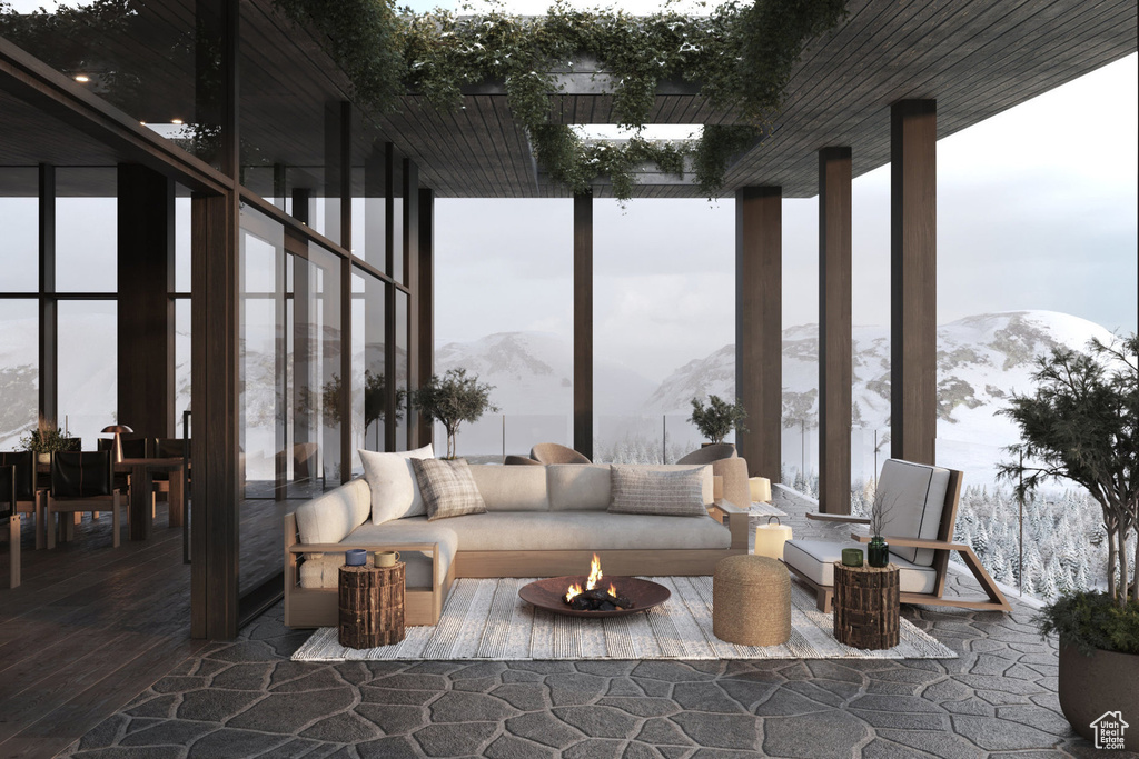 View of patio / terrace with a mountain view and an outdoor living space with a fire pit