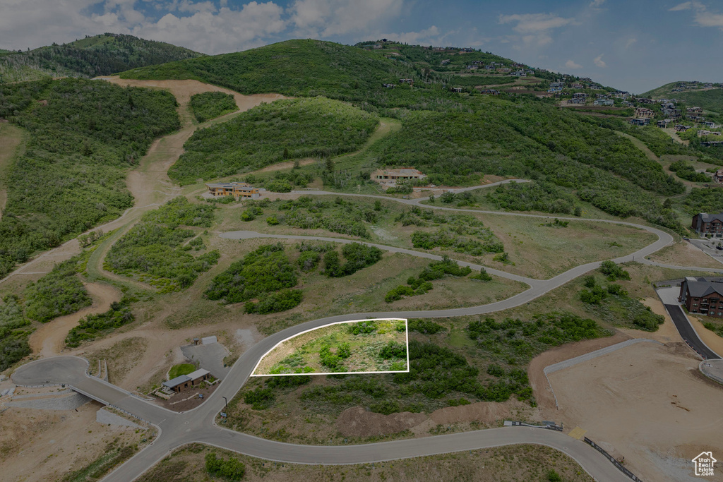 Aerial view of property and surrounding area with property boundaries highlighted and mountains