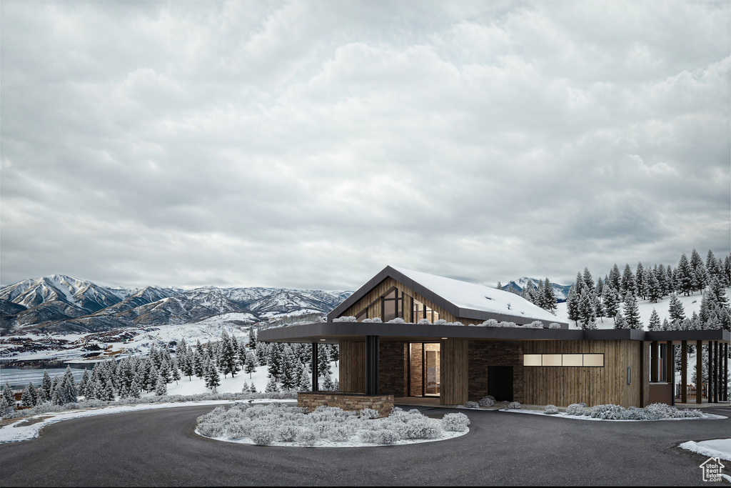Snow covered building featuring a mountain view
