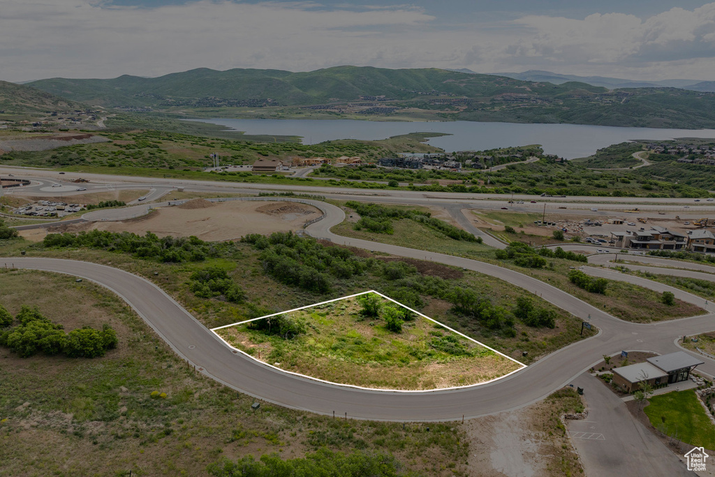 Aerial view of property and surrounding area with a water and mountain view and property boundaries highlighted