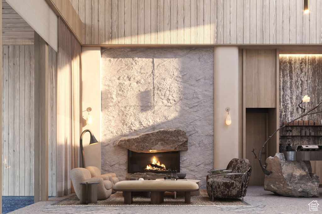Living room with a stone fireplace and carpet flooring