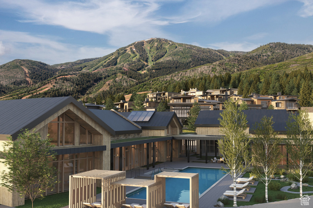 Back of property featuring a mountain view and a residential view