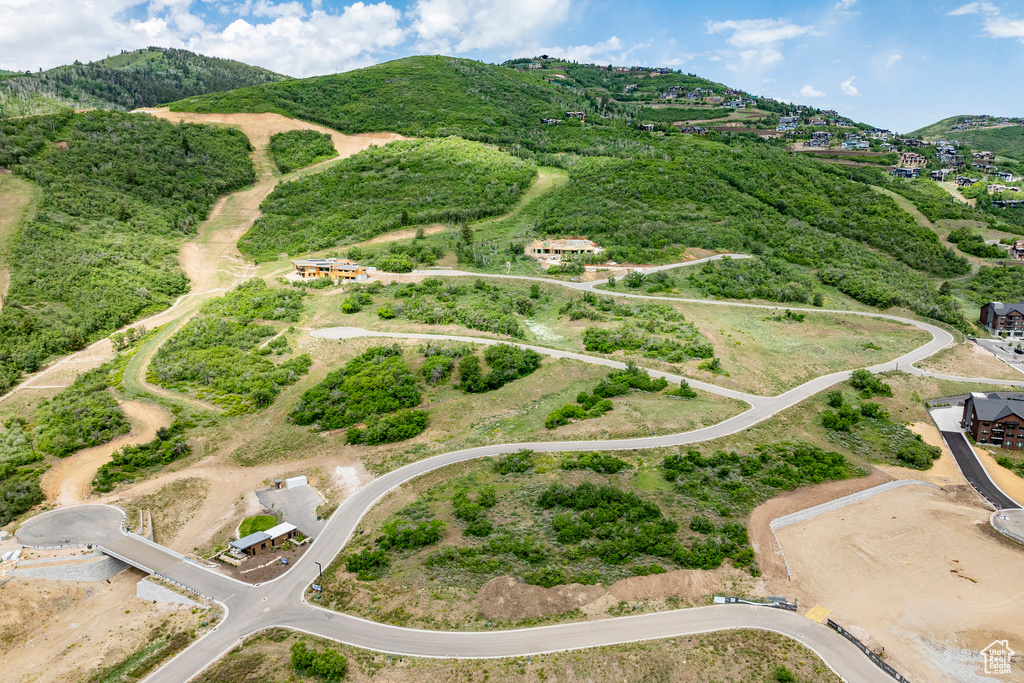 Aerial view of property's location with a mountain backdrop