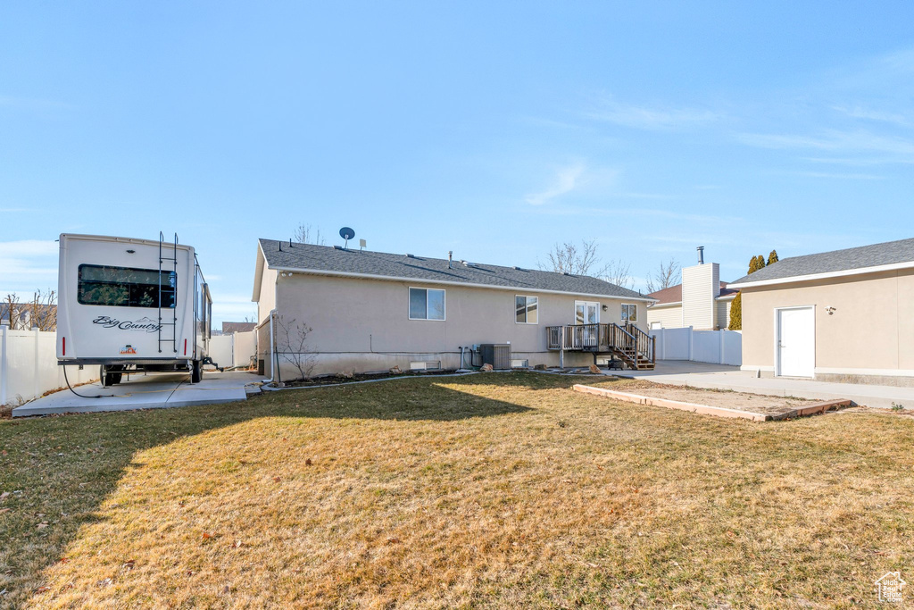 Back of property featuring a yard, a patio area, fence, and central air condition unit