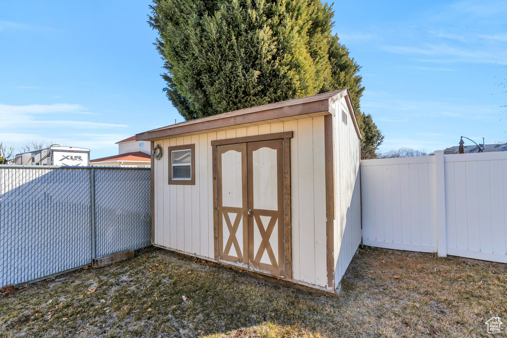 View of shed with a fenced backyard