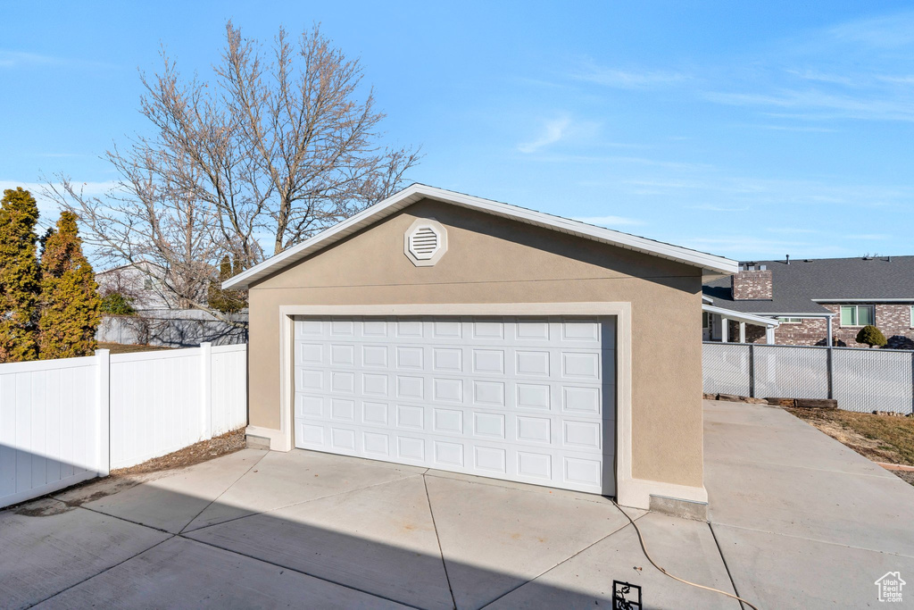 Detached garage featuring fence
