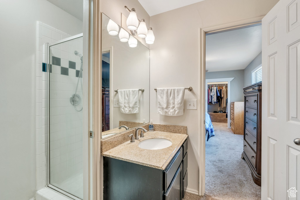Full bath featuring a stall shower, ensuite bath, and vanity