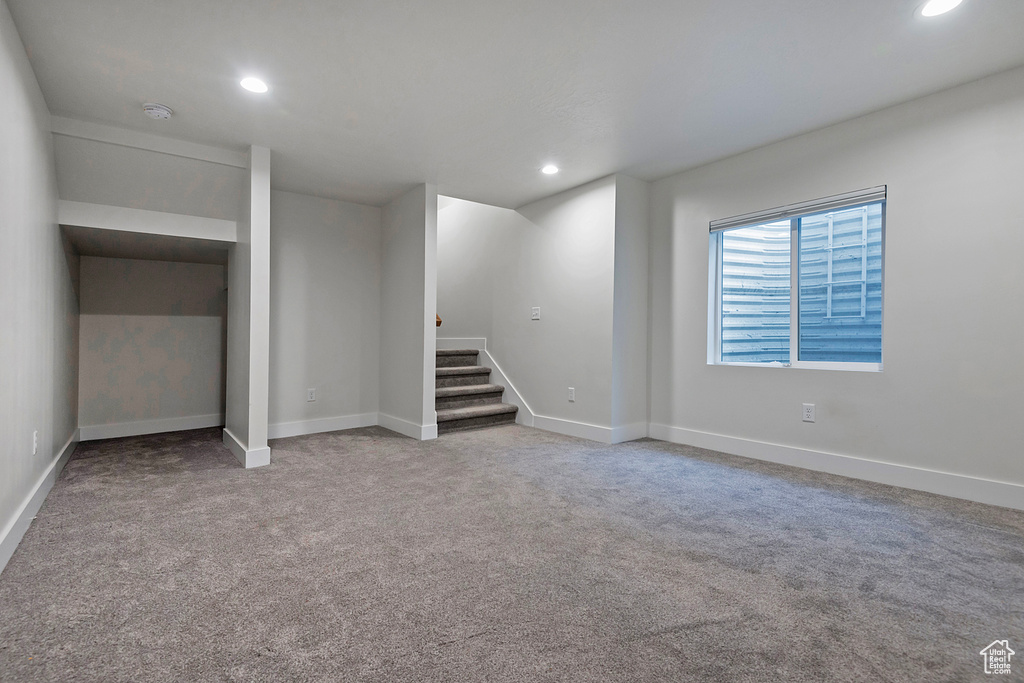 Interior space featuring light carpet, baseboards, and recessed lighting