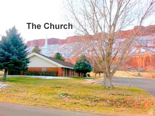 View of side of home featuring a mountain view and a yard