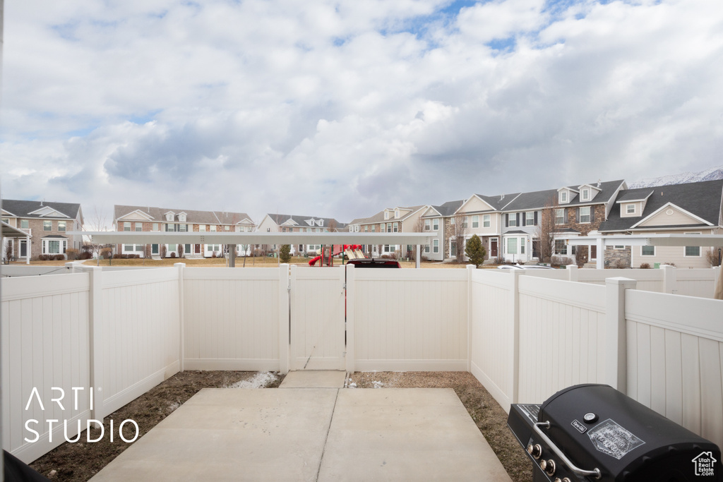 View of patio / terrace with a fenced backyard and a residential view