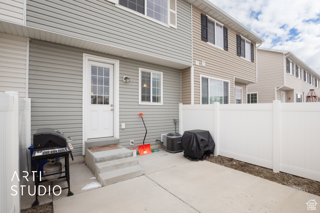 View of patio / terrace with fence, grilling area, and central AC unit