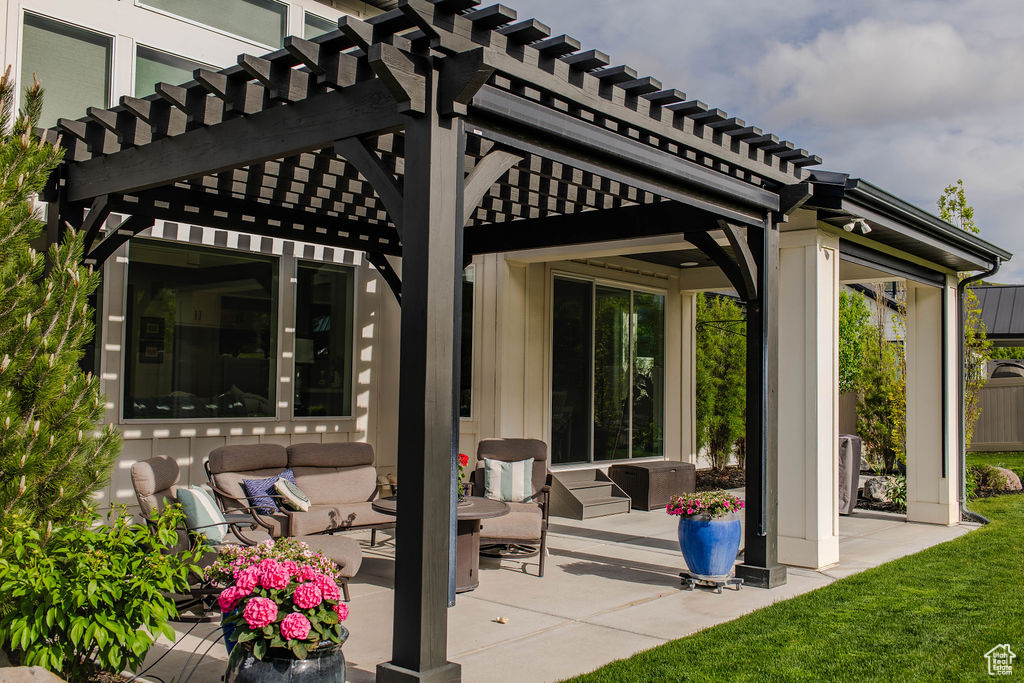 View of patio featuring outdoor lounge area and a pergola