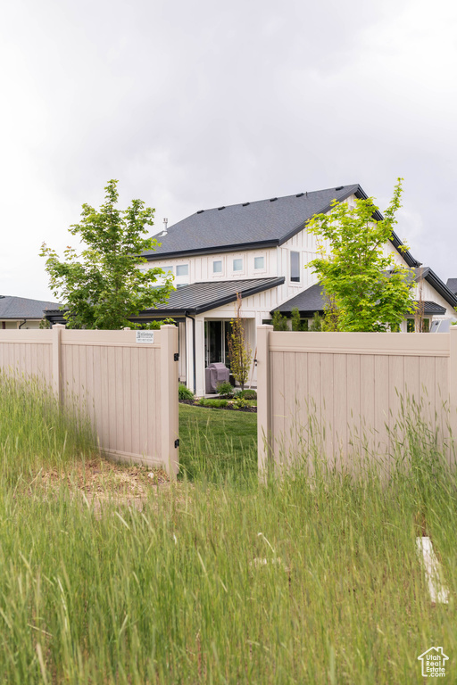 Back of house with fence