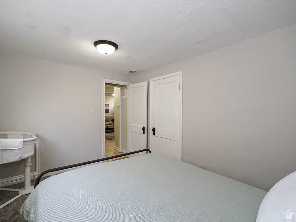Bedroom with light colored carpet