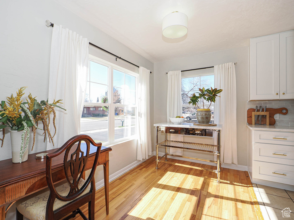 Dining space with light wood-type flooring and baseboards