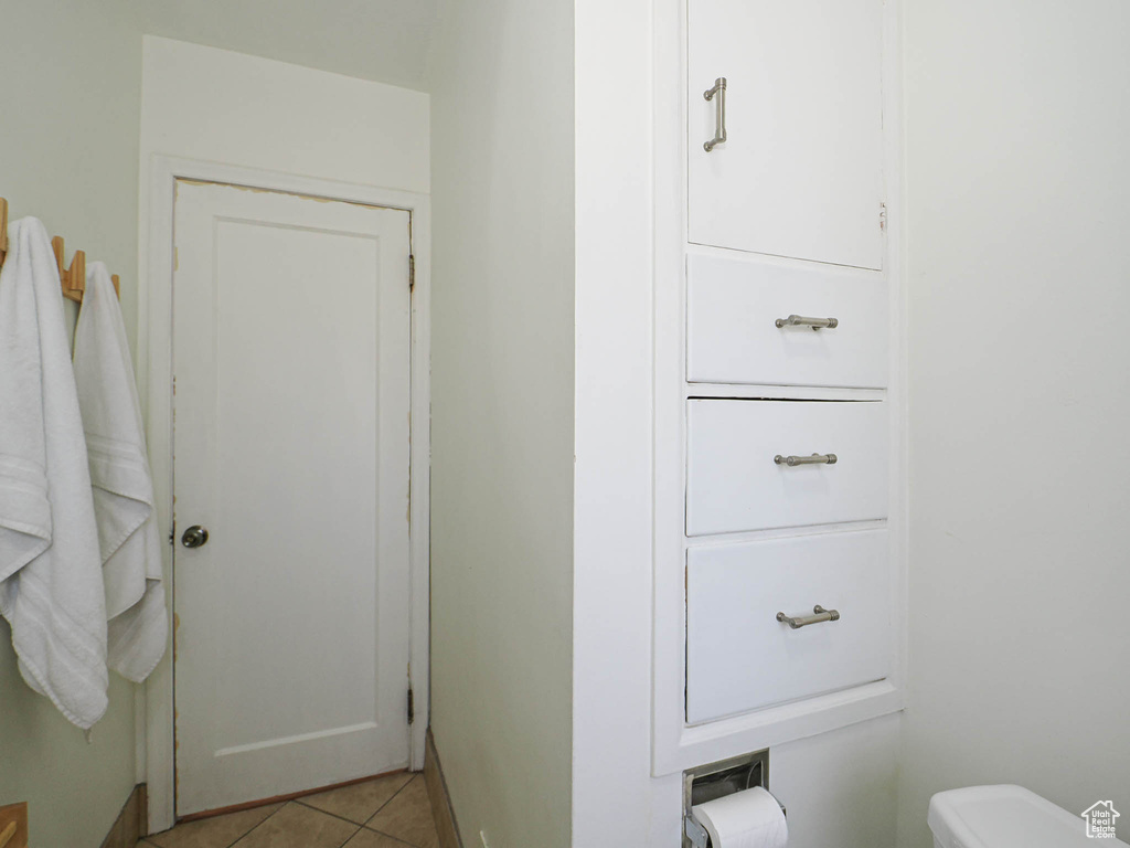 Half bath featuring tile patterned flooring and toilet
