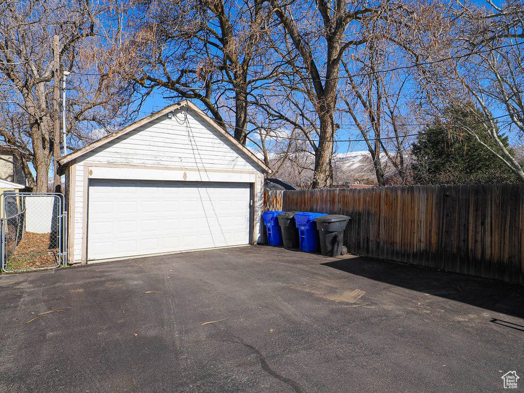 Detached garage with fence and a mountain view