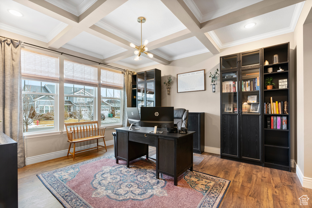 Office space with beam ceiling, coffered ceiling, baseboards, and wood finished floors