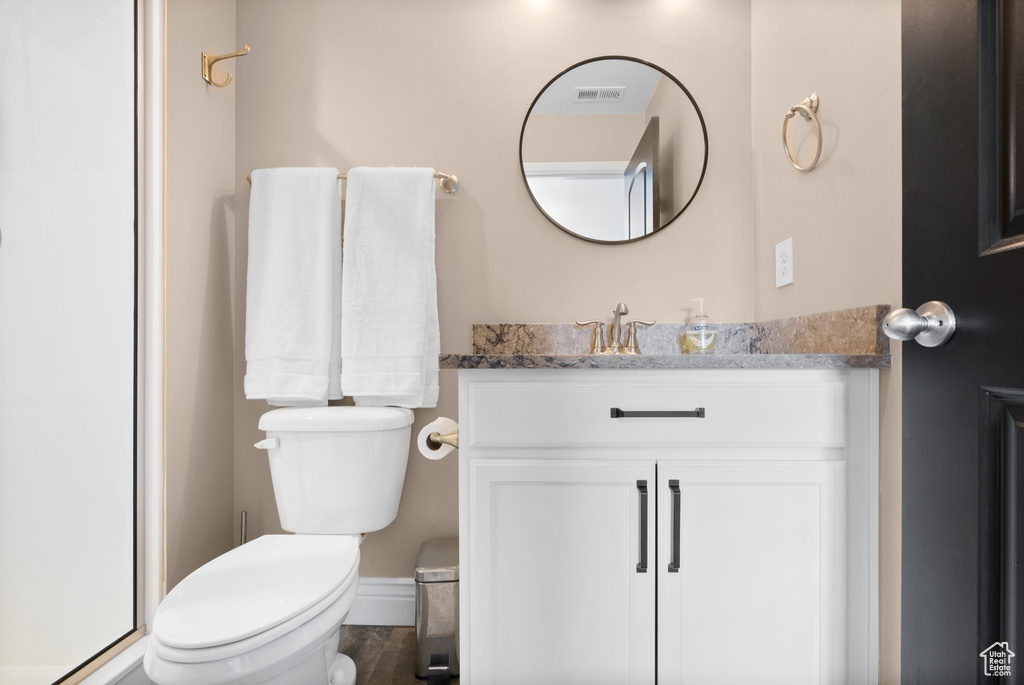 Bathroom with visible vents, vanity, and toilet