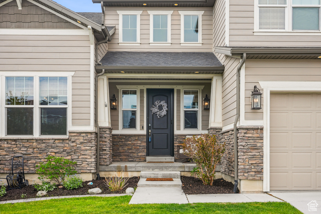 View of exterior entry with stone siding
