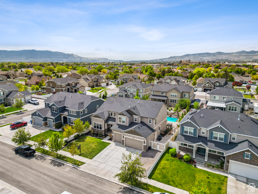 Aerial view of residential area featuring a mountainous background