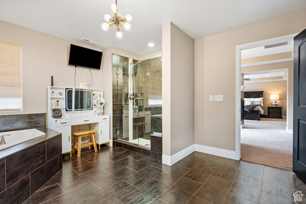 Full bath with a stall shower, visible vents, a notable chandelier, and a bath