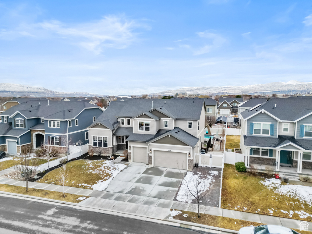 Snowy aerial view with a mountain view and a residential view