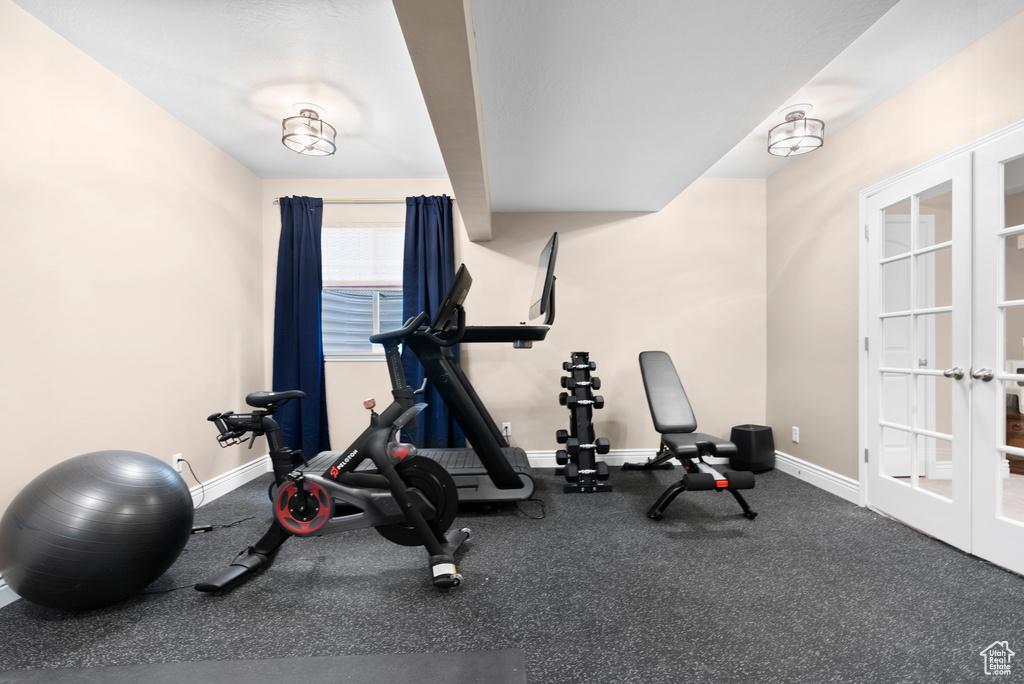 Exercise area featuring french doors and baseboards