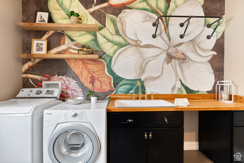 Laundry room with tile patterned floors, a sink, cabinet space, and washer and dryer