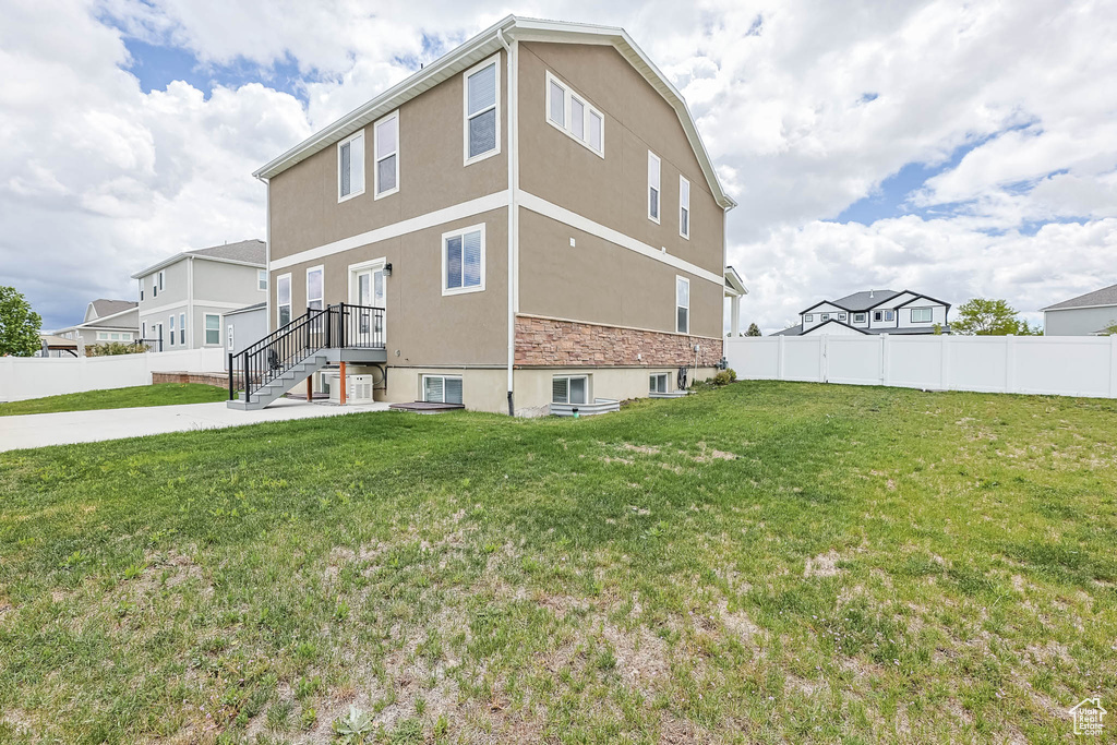 View of home's exterior with stucco siding and stone siding