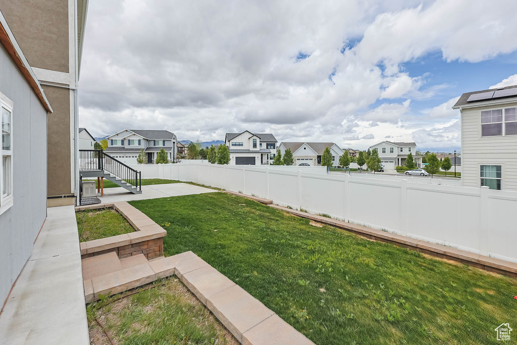 View of yard featuring a residential view and a patio area