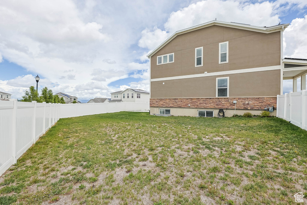 Back of house with stucco siding and stone siding