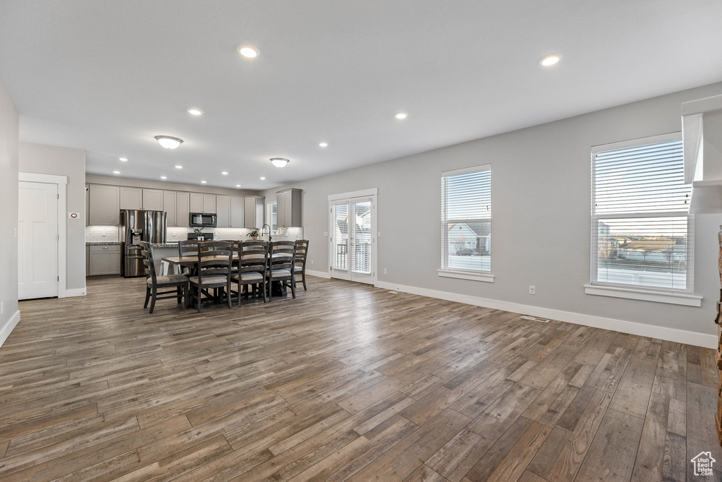 Dining room featuring baseboards, wood finished floors, and recessed lighting