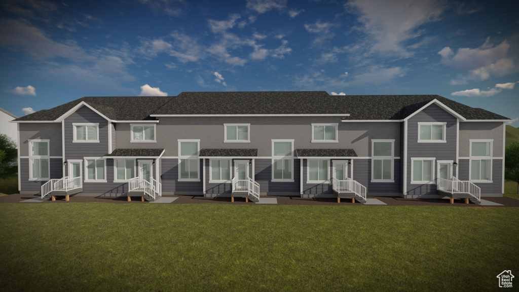 Back of house with a lawn