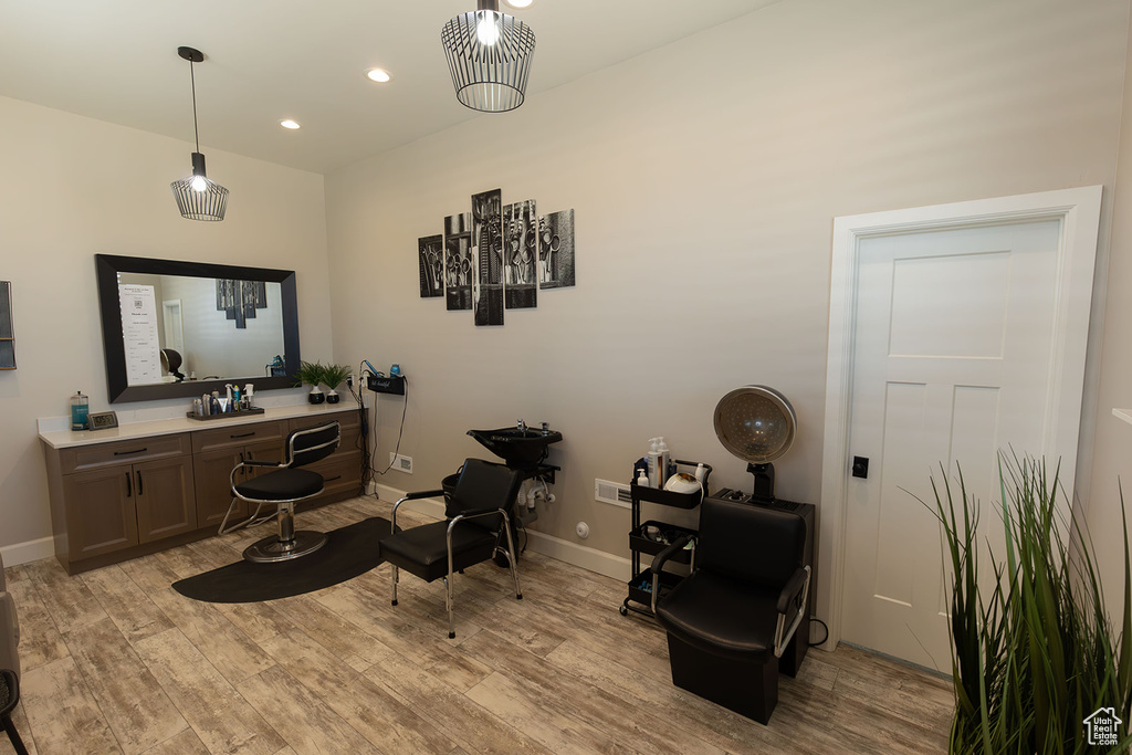 Living area featuring baseboards, recessed lighting, and light wood-style floors