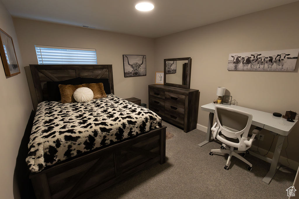 Bedroom with light carpet, baseboards, and visible vents