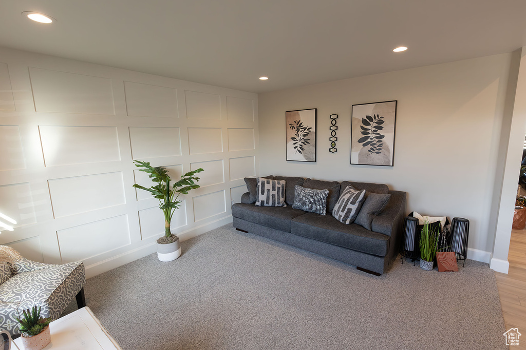 Living room featuring recessed lighting and a decorative wall