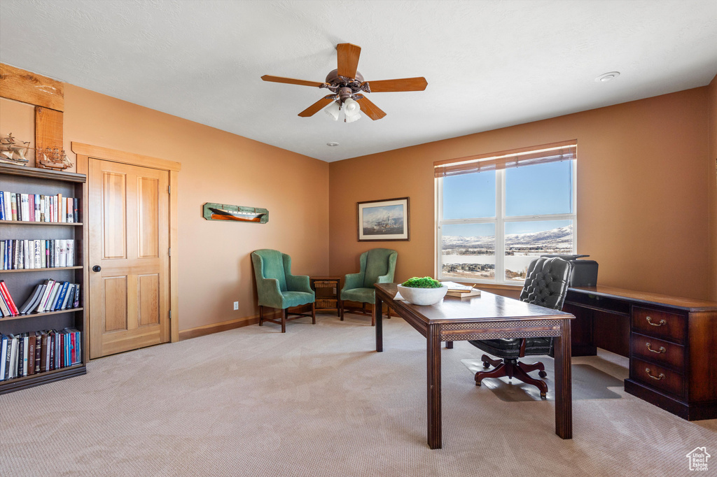 Office featuring light carpet, ceiling fan, and baseboards