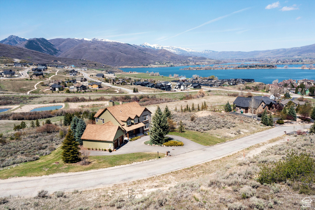 Birds eye view of property with a water and mountain view
