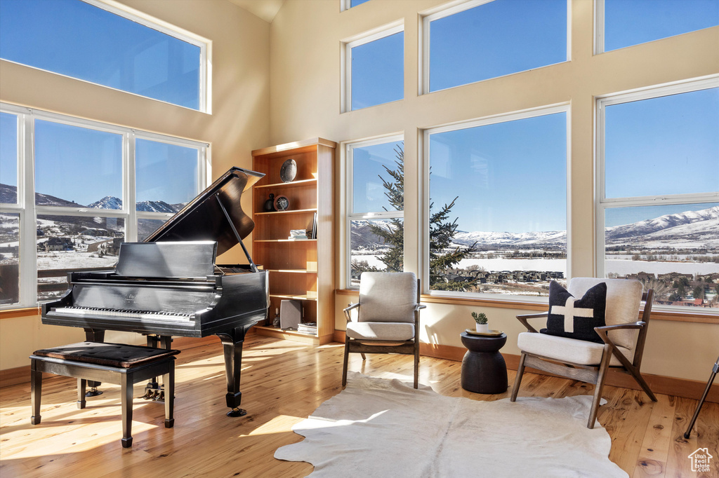 Sitting room with baseboards, a mountain view, and hardwood / wood-style floors