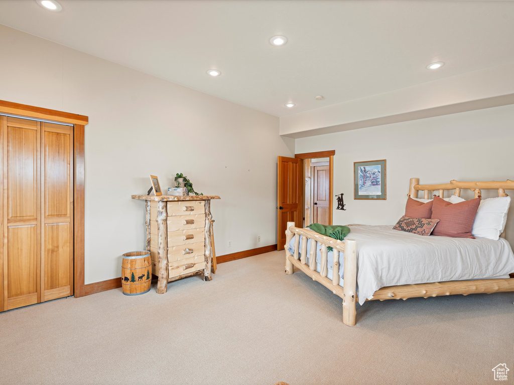 Bedroom featuring recessed lighting, light colored carpet, and baseboards