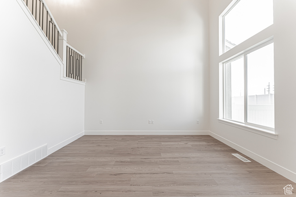 Empty room with light wood-style floors and baseboards