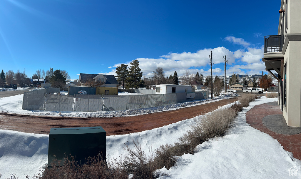 Yard covered in snow with fence