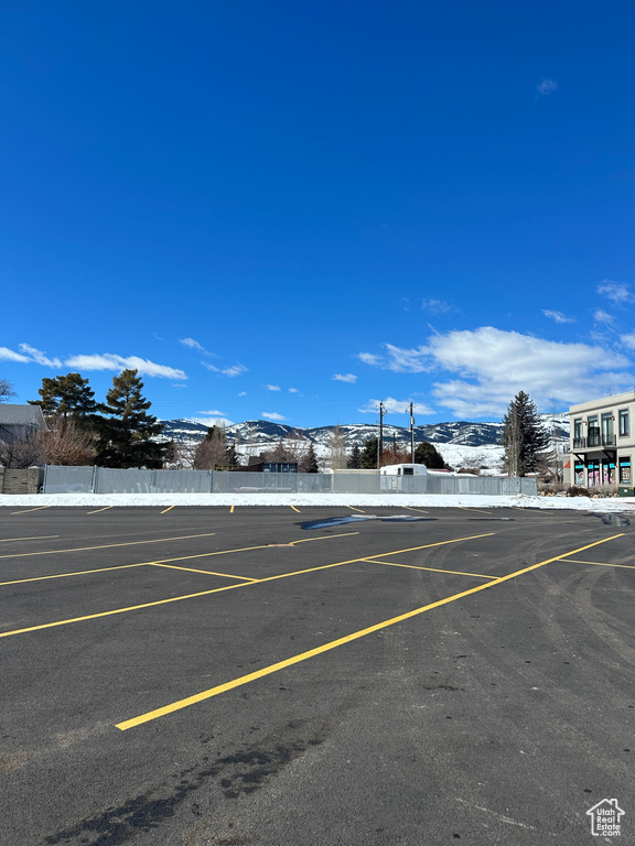 Uncovered parking lot featuring a mountain view