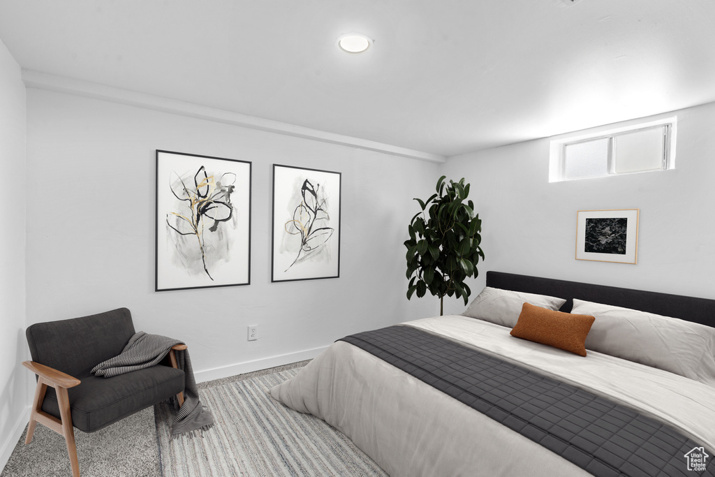 Carpeted bedroom featuring baseboards
