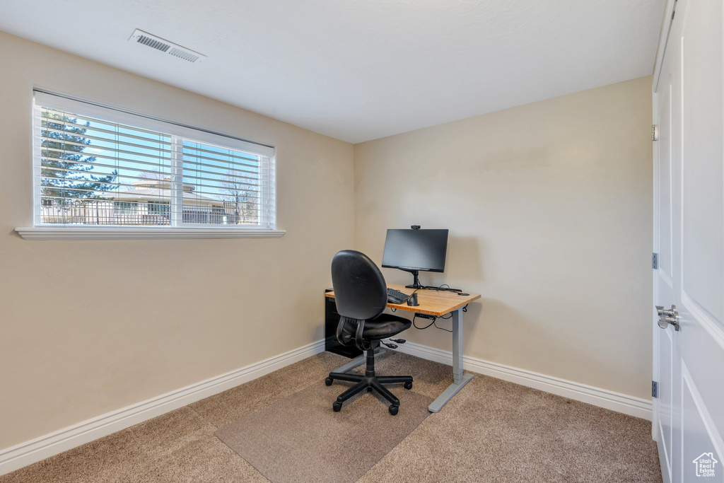 Office space featuring carpet, visible vents, and baseboards