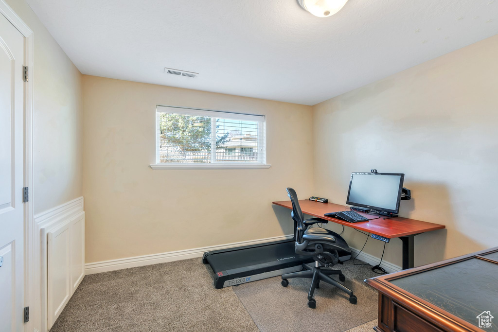 Office space with baseboards, visible vents, and carpet flooring