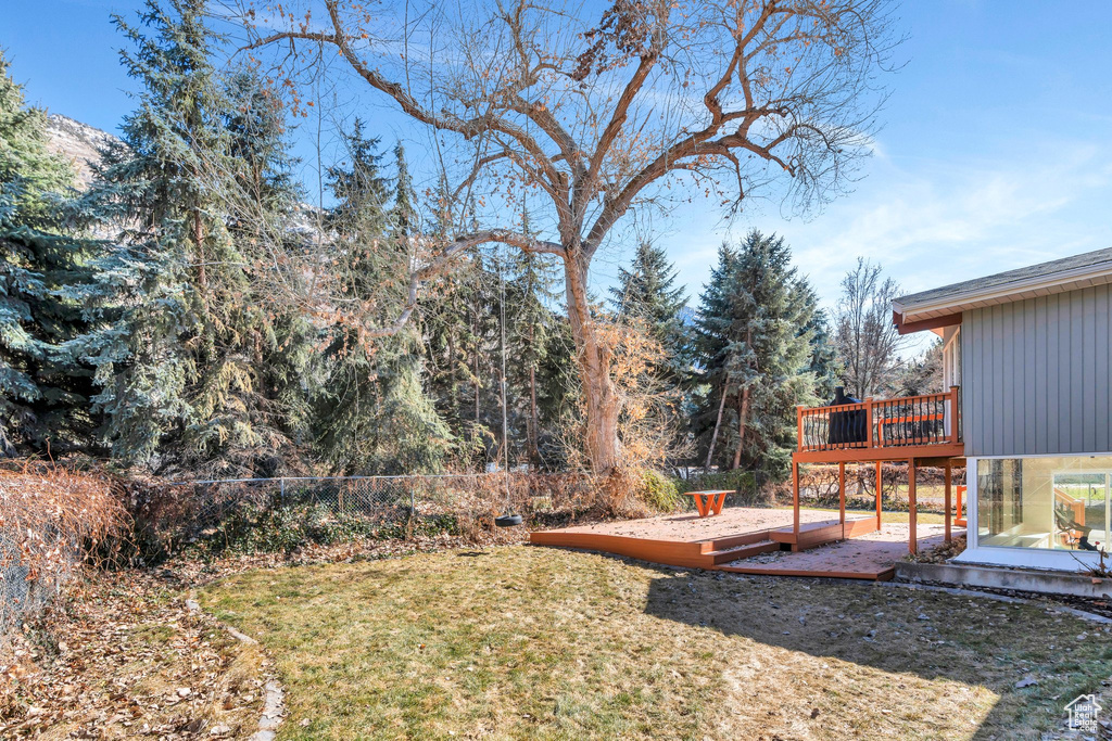 View of yard featuring a deck and fence