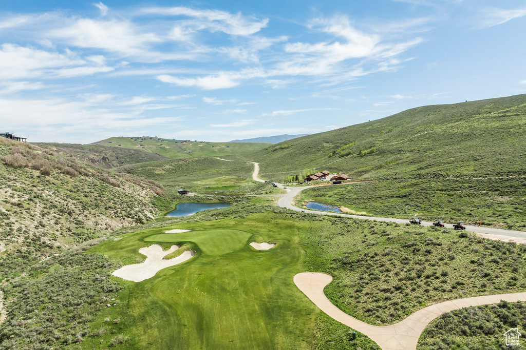 Drone / aerial view of a water and mountain view and a golf course